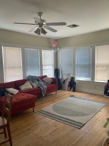 a living room with furniture and a chandelier