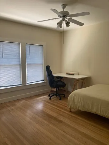 a living room with a bed furniture and a window