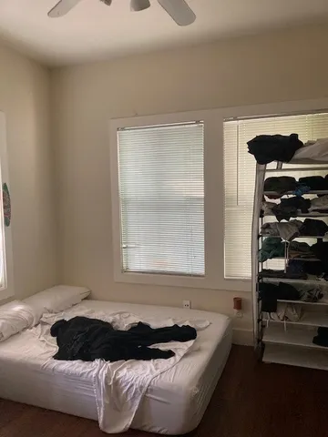 a bedroom with a bed and a window