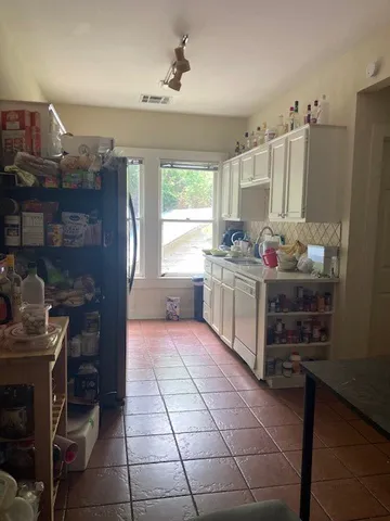 a kitchen with stainless steel appliances a stove a sink and a refrigerator