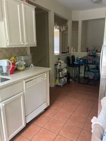 a view of a storage & utility room with cabinets