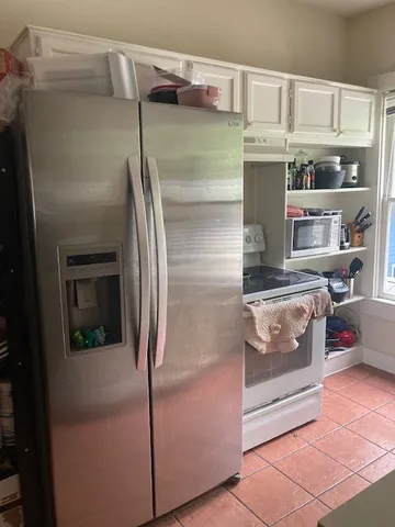 a kitchen with a refrigerator and a stove