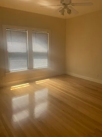 a view of a room with wooden floor