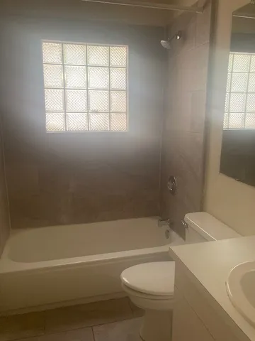 an empty room with a empty space and windows