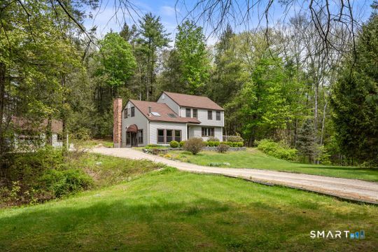 26 Old Coach Road Barkhamsted, CT 06063 - Photo 3 of 35 a front view of a house with a yard table and chairs