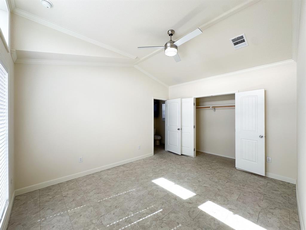153 Cabrera Street Oak Point, TX 75068 - Photo 3 of 22 Vaulted ceiling with crown molding, modern ceiling fan, large window with blinds, tile flooring, and a double-door closet