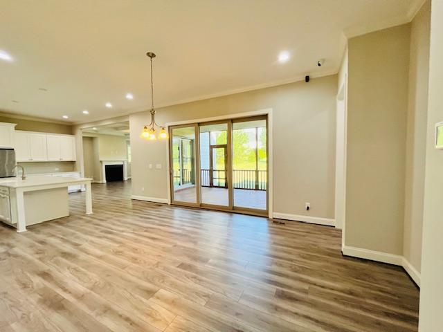 1717 Banks View Drive Raleigh, NC 27603 - Photo 8 of 33 a view of an empty room with wooden floor and a kitchen