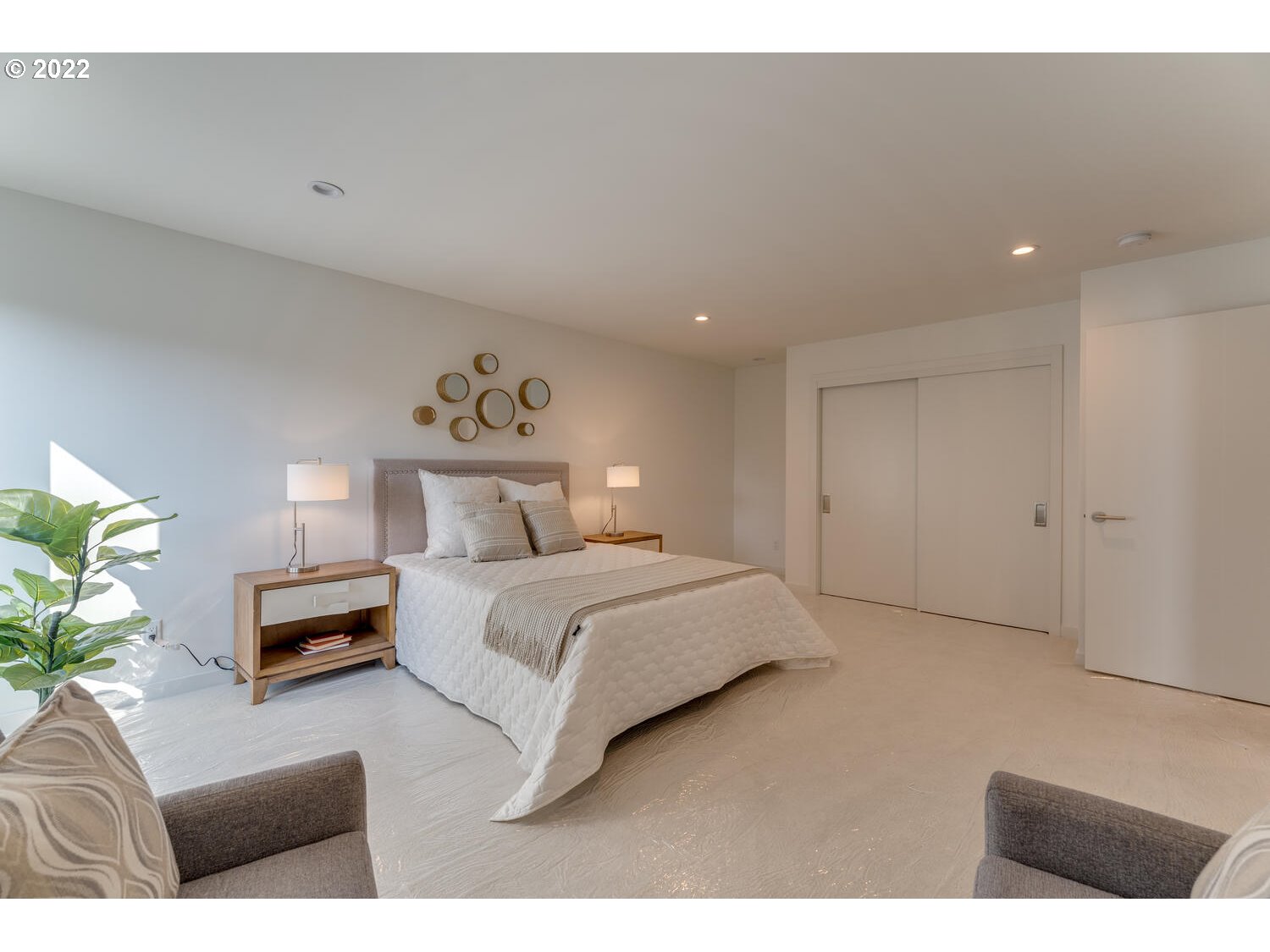 10424 Northwest Laidlaw Road Portland, OR 97229 - Photo 13 of 32 a spacious bedroom with a bed and a couch