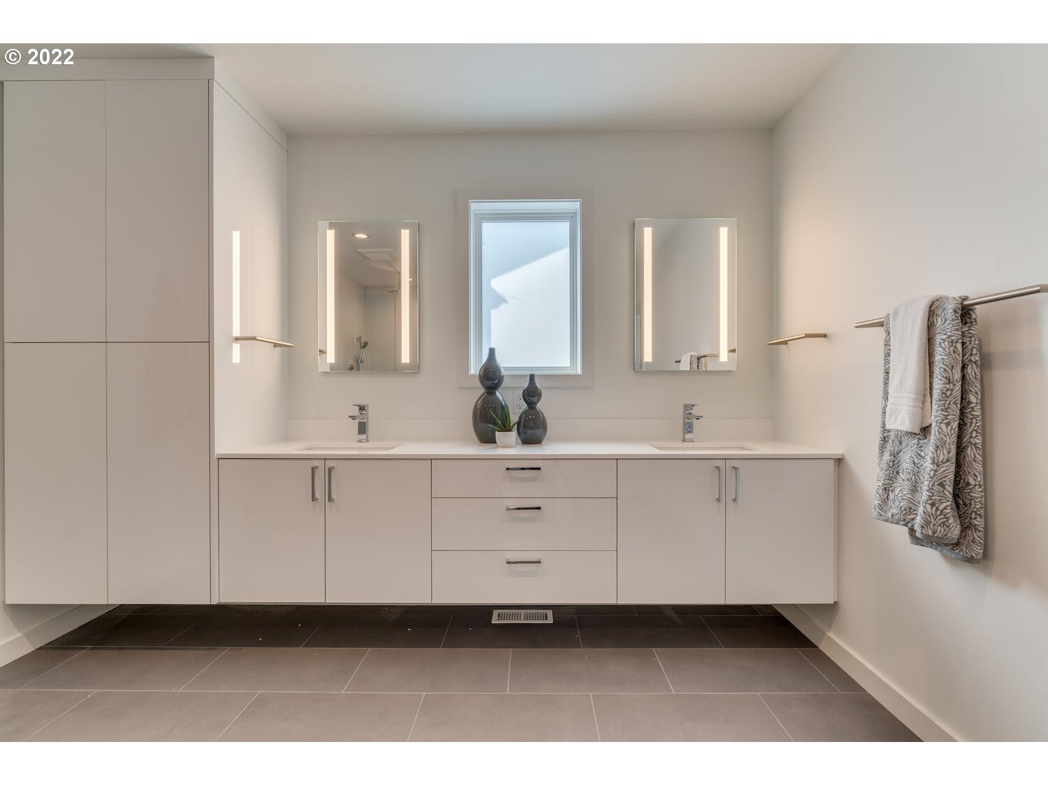 10424 Northwest Laidlaw Road Portland, OR 97229 - Photo 14 of 32 a bathroom with a double vanity sink a mirror and a bathtub