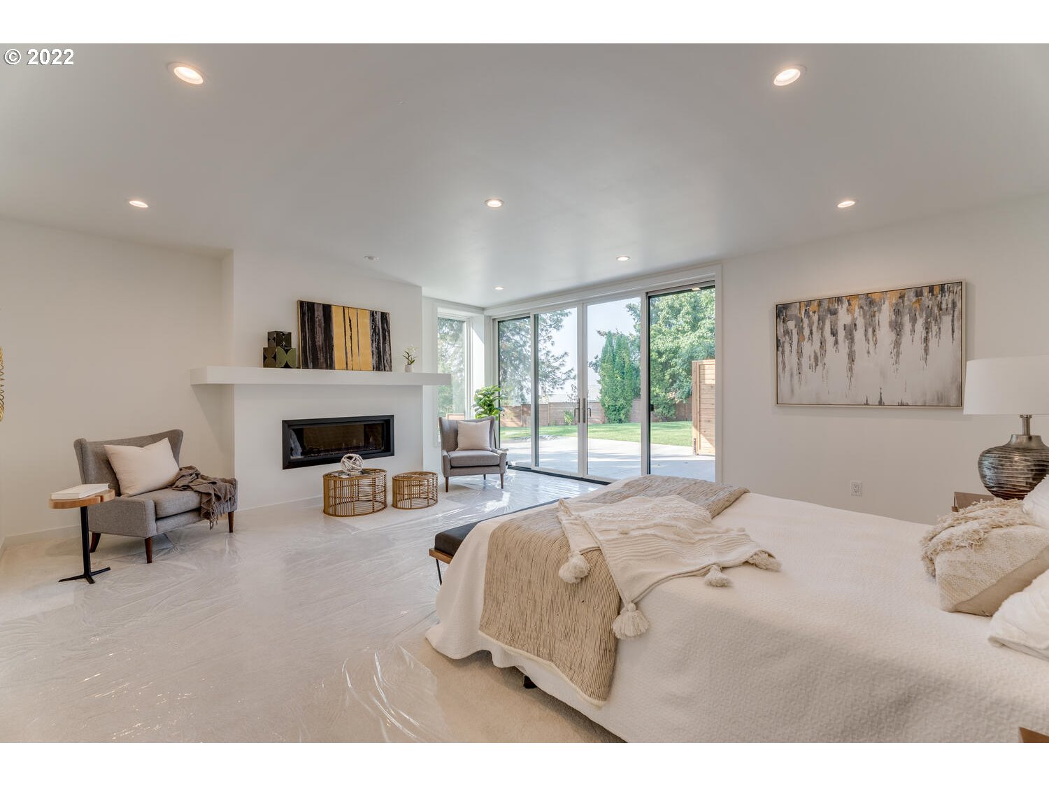 10424 Northwest Laidlaw Road Portland, OR 97229 - Photo 23 of 32 a bedroom with a bed and a fireplace