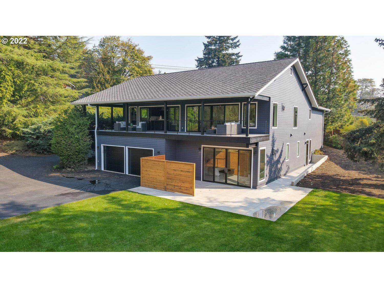 10424 Northwest Laidlaw Road Portland, OR 97229 - Photo 27 of 32 a backyard of a house with table and chairs