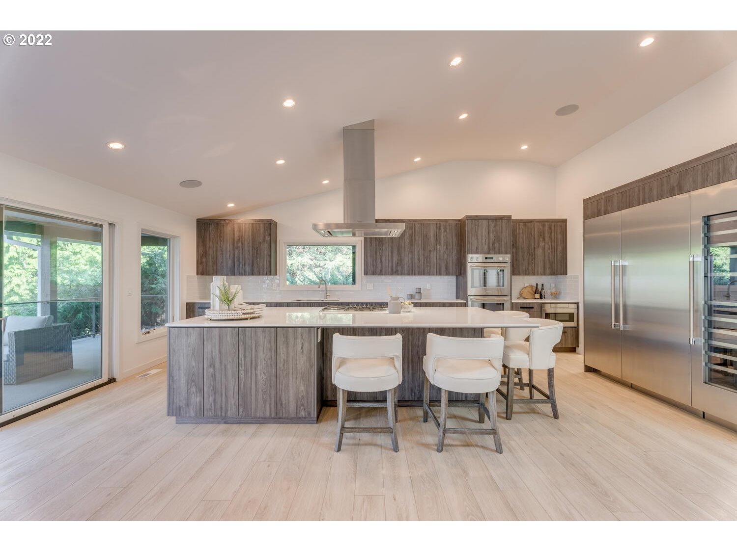 10424 Northwest Laidlaw Road Portland, OR 97229 - Photo 3 of 32 a dining area with a table chairs and kitchen view