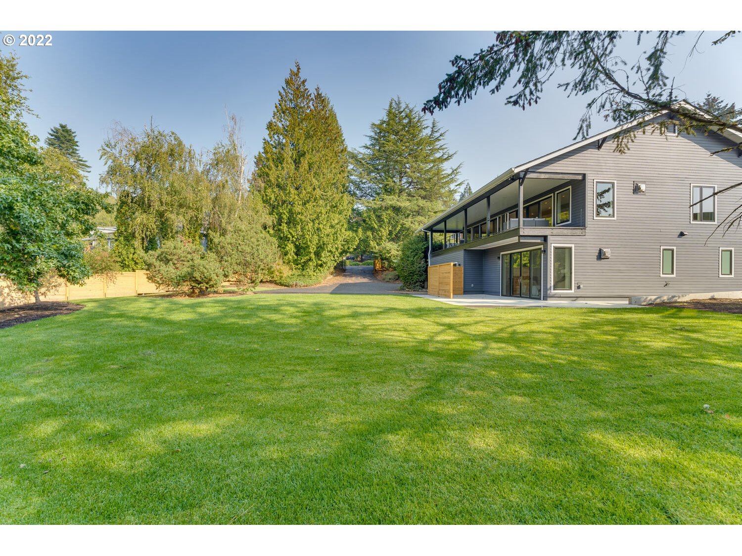10424 Northwest Laidlaw Road Portland, OR 97229 - Photo 31 of 32 a backyard of a house with lots of green space