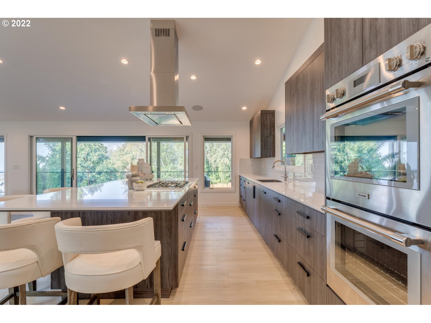 10424 Northwest Laidlaw Road Portland, OR 97229 - Photo 5 of 32 a large kitchen with kitchen island a large window in it