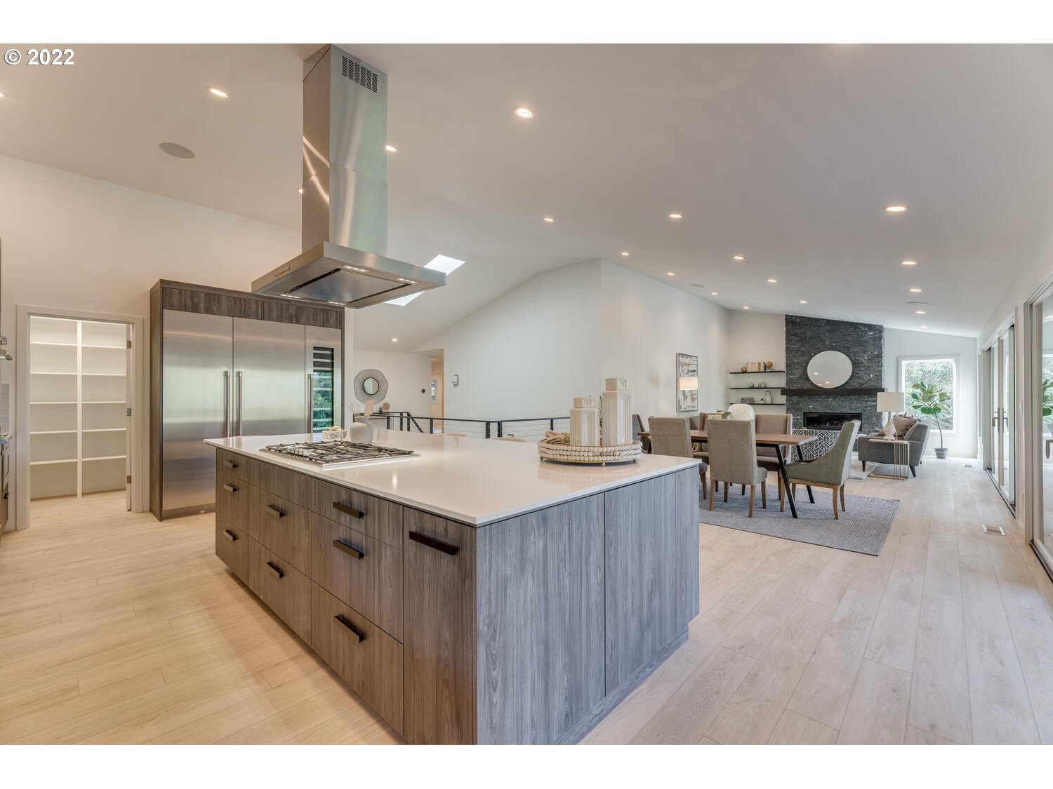 10424 Northwest Laidlaw Road Portland, OR 97229 - Photo 6 of 32 a kitchen with stainless steel appliances kitchen island wooden cabinets and a table