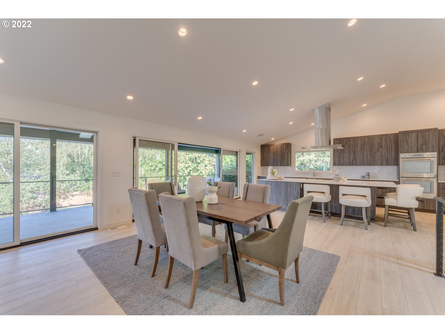 10424 Northwest Laidlaw Road Portland, OR 97229 - Photo 8 of 32 a dining room with furniture and a floor to ceiling window