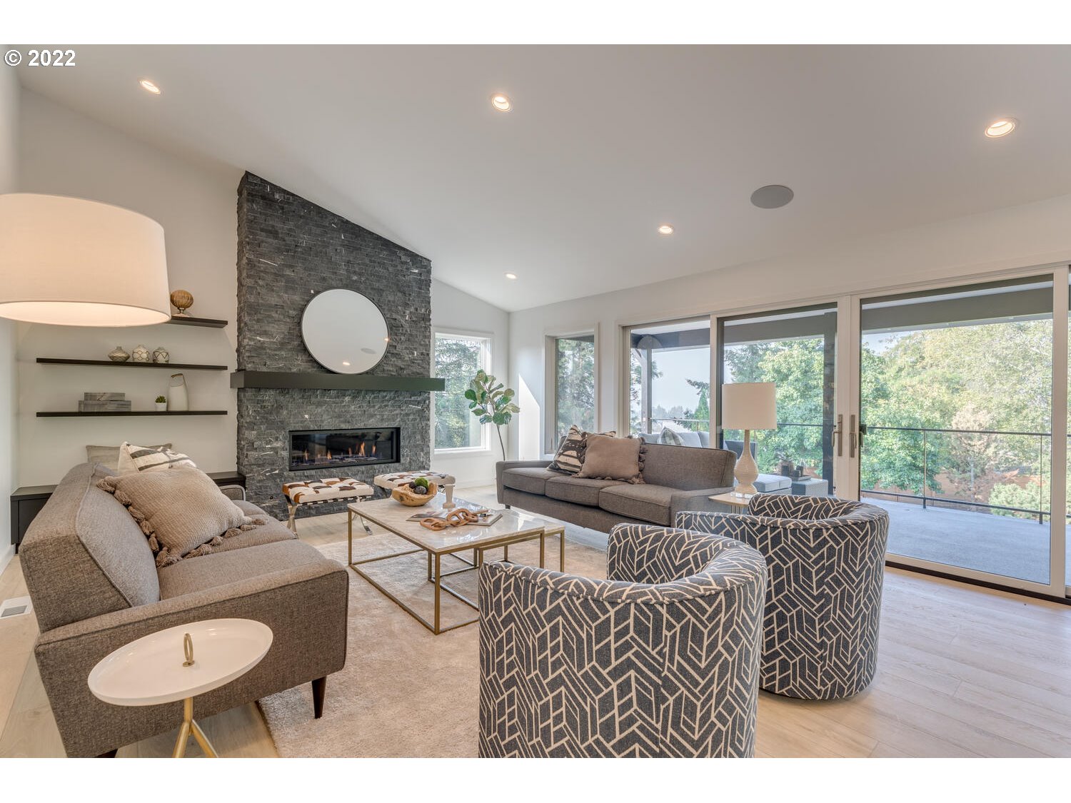 10424 Northwest Laidlaw Road Portland, OR 97229 - Photo 10 of 32 a living room with furniture a fireplace and a large window