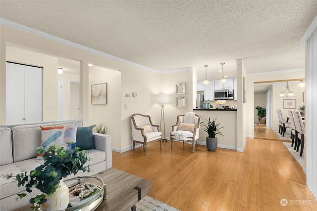 a living room with furniture and a kitchen view