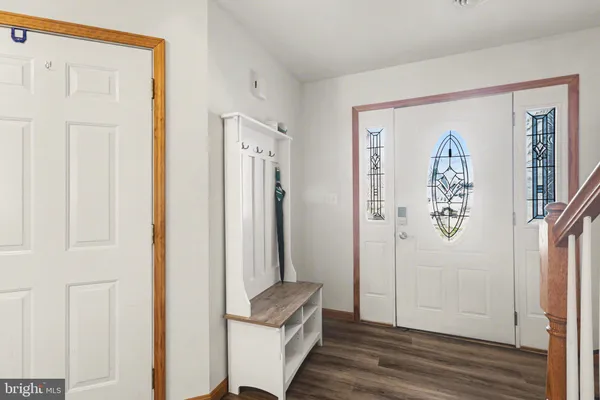 a view of a hallway with closet and wooden floor