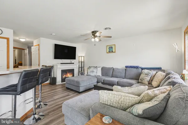 a living room with furniture a fireplace and a flat screen tv