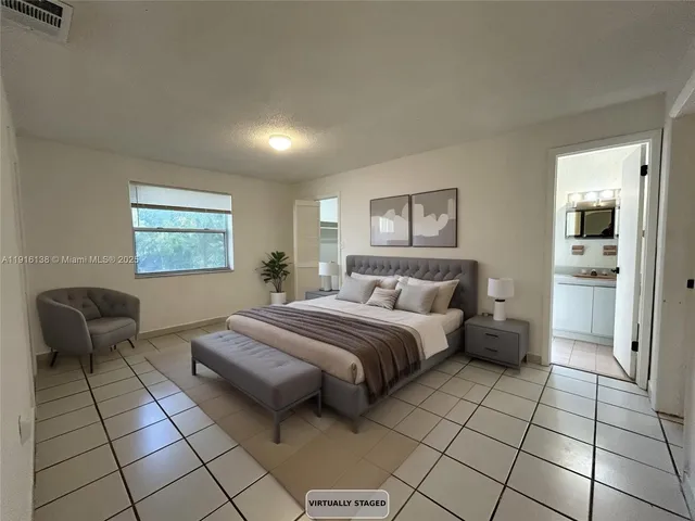 a spacious bedroom with a bed and furniture