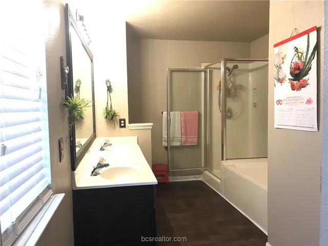 a bathroom with a tub and a shower