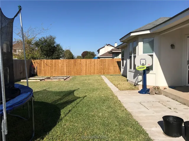 a view of swimming pool with a backyard