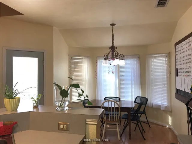 a view of a dining room with furniture and window