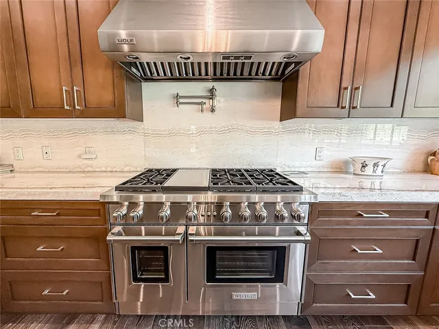 a stove top oven sitting inside of a kitchen