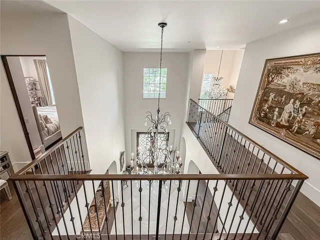 a view of a hallway with wooden floor and windows