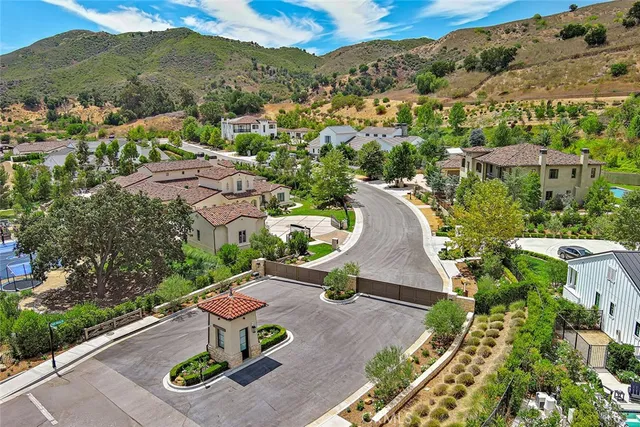 an aerial view of residential houses with outdoor space and street view