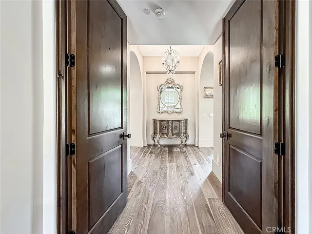 a kitchen with stainless steel appliances a refrigerator and wooden floor