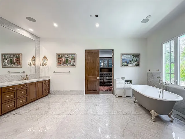 a spacious bathroom with a double vanity sink tub and shower