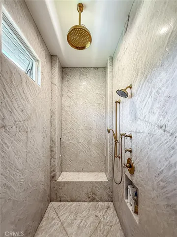 a bathroom with a granite countertop shower