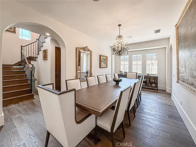 a view of a a dining room with furniture window and wooden floor