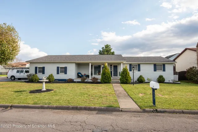 a view of a house with a swimming pool and a yard