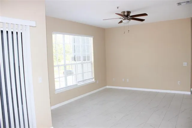 a view of room with window and ceiling fan