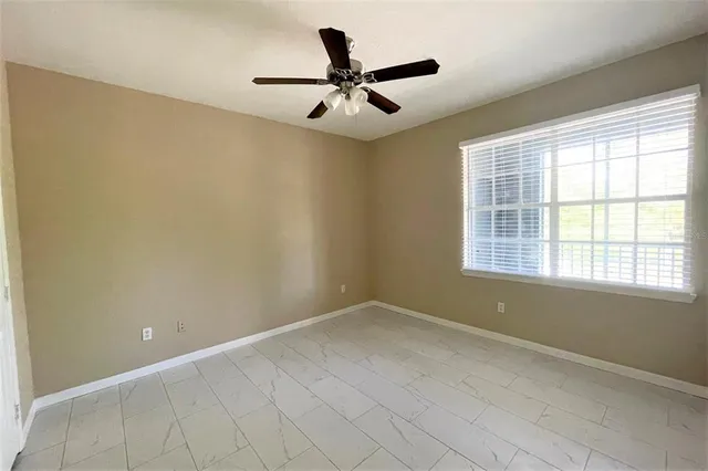 an empty room and a ceiling fan