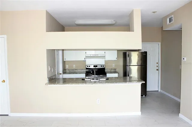 a kitchen with a refrigerator sink and stove