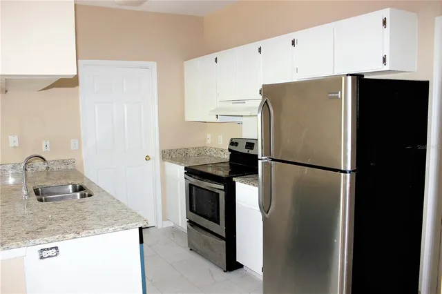 a kitchen with a sink and a refrigerator