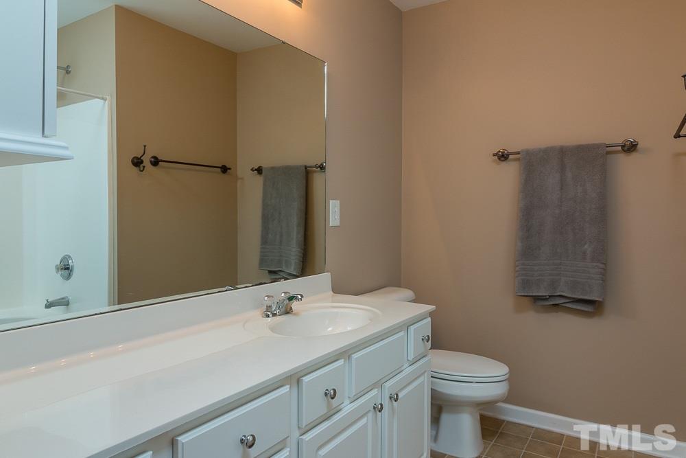7839 Silverthread Lane Raleigh, NC 27617 - Photo 13 of 23 a bathroom with a sink toilet and shower