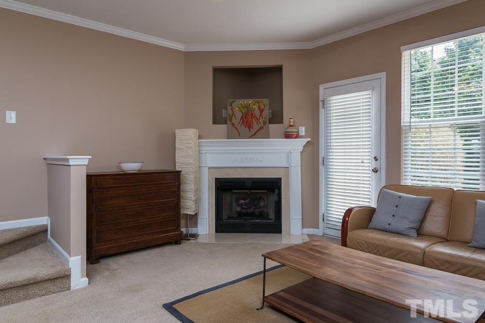 7839 Silverthread Lane Raleigh, NC 27617 - Photo 5 of 23 a living room with furniture and a fireplace