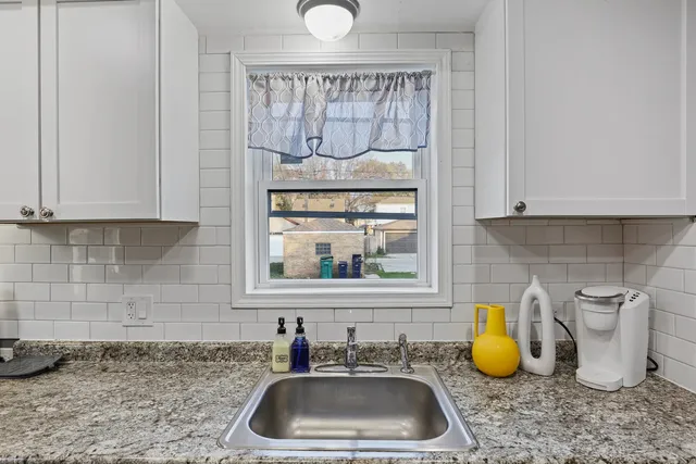 a kitchen with a sink and a window