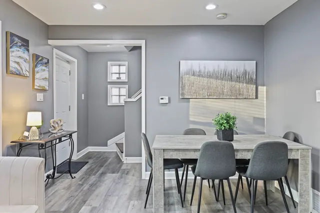 a view of a dining room with furniture and wooden floor