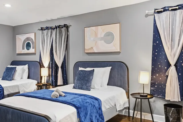 a bedroom with bed and a mirror