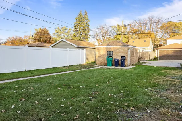 a view of a house with a yard and sitting area