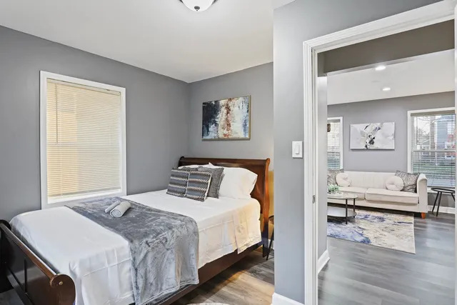 a bedroom with a bed and wooden floor