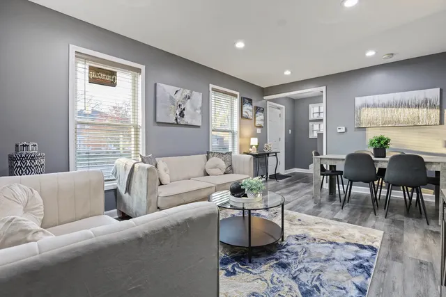 a living room with furniture potted plant and window