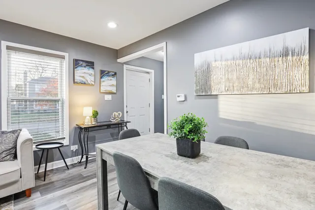 a dining room with furniture and wooden floor