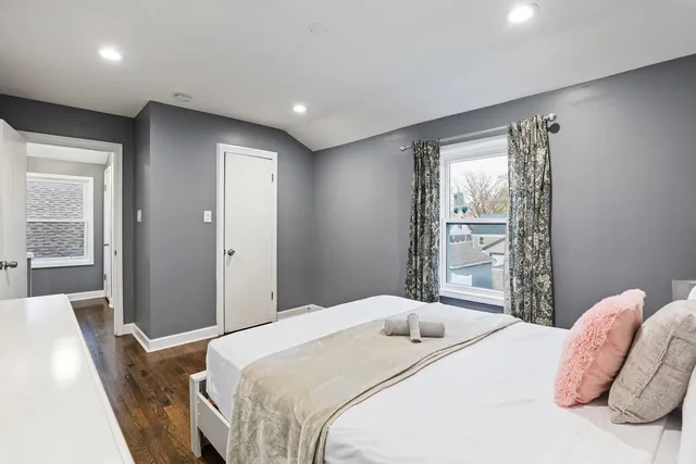 a bedroom with a bed and a large mirror